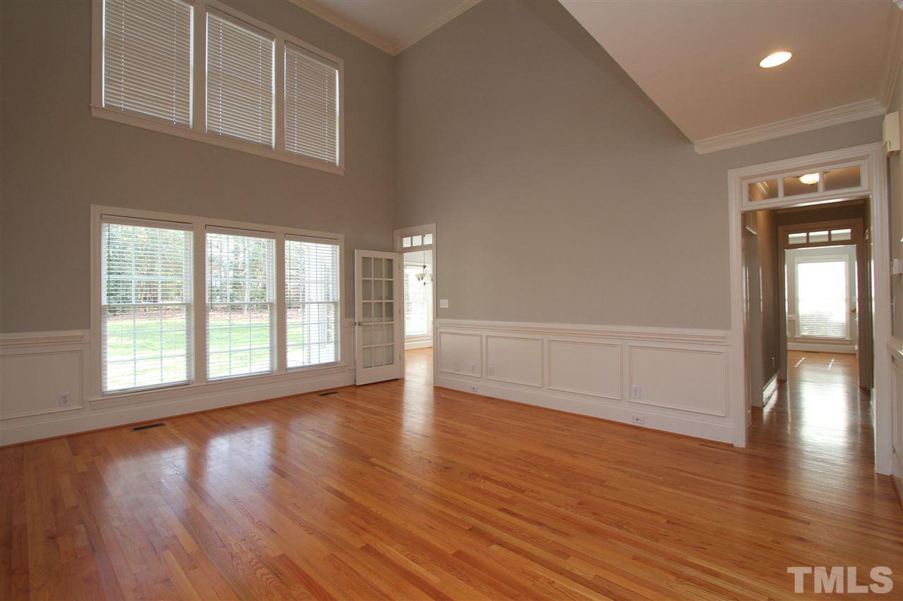 7121 Trenton Ridge Court Raleigh, NC 27613 - Photo 5 of 25 a view of an empty room with wooden floor and a window