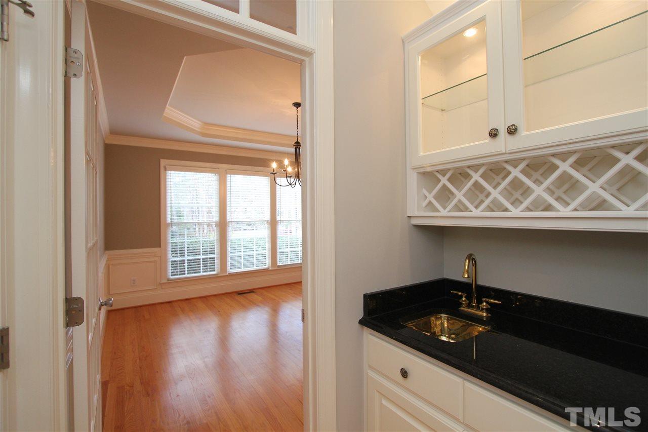 7121 Trenton Ridge Court Raleigh, NC 27613 - Photo 9 of 25 a close view of a utility room with wooden floor and cabinets