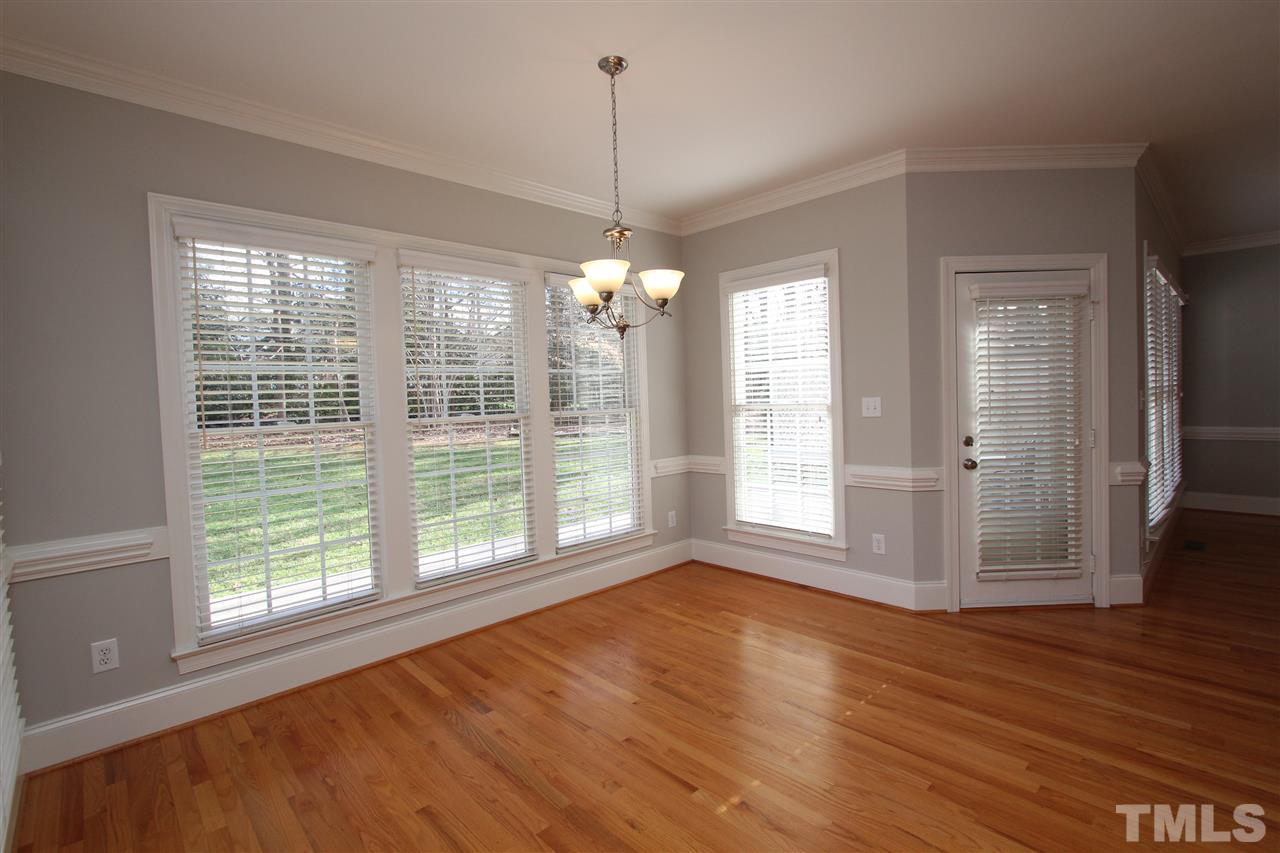7121 Trenton Ridge Court Raleigh, NC 27613 - Photo 10 of 25 a view of an empty room with wooden floor and a window