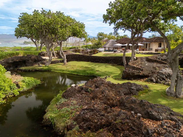 a vase of flowers sitting on a table with a vase on both of a sink