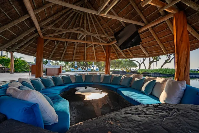 a view of a patio with table and chairs potted plants and palm tree