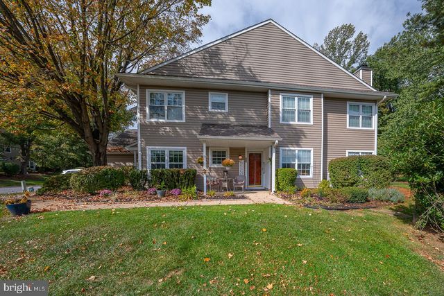 a front view of a house with a yard table and chairs