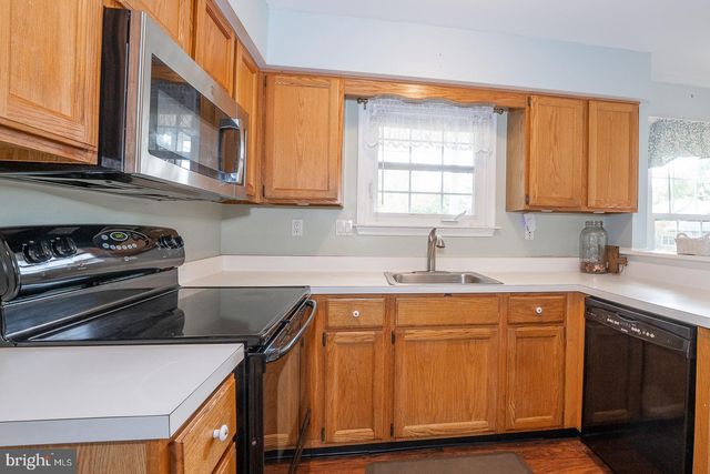 a kitchen with wooden cabinets and a sink