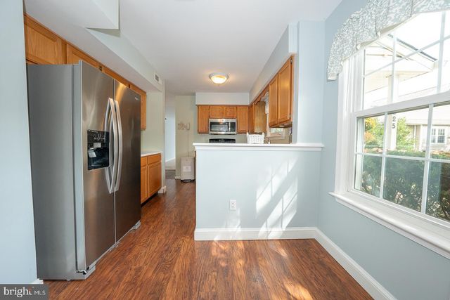 a kitchen with stainless steel appliances a refrigerator and a stove top oven