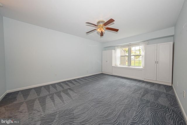 a view of empty room with ceiling fan