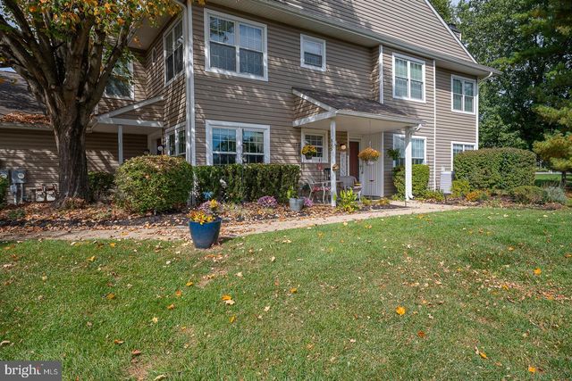 a view of a house with backyard porch and sitting area