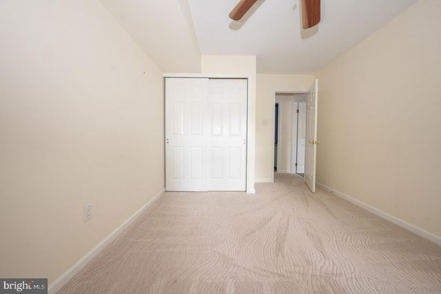 a view of an empty room with a ceiling fan