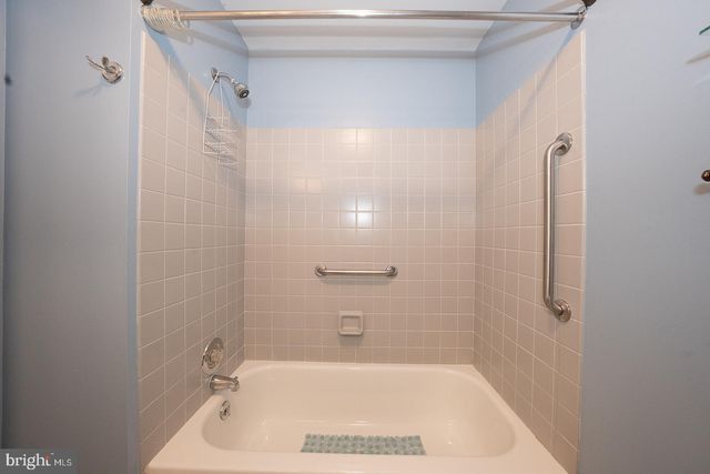 a bathroom with a shower and a bath tub