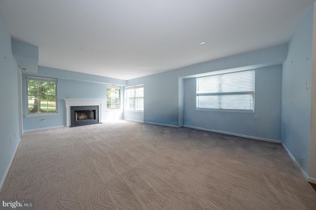 a view of empty room with window and fireplace