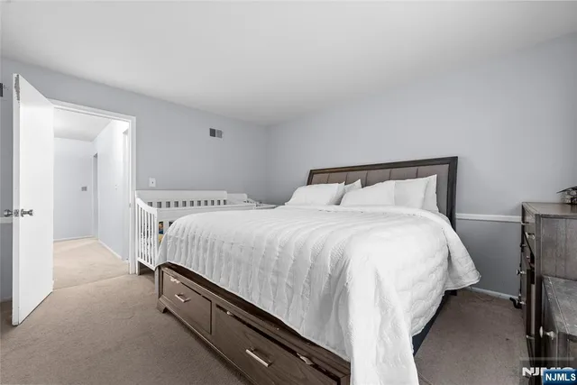 a bedroom with a bed and a night stand