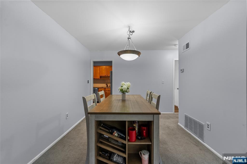 181 Long Hill Road, Unit 116 Little Falls, NJ 07424 - Photo 6 of 19 a dining room with a table and chairs