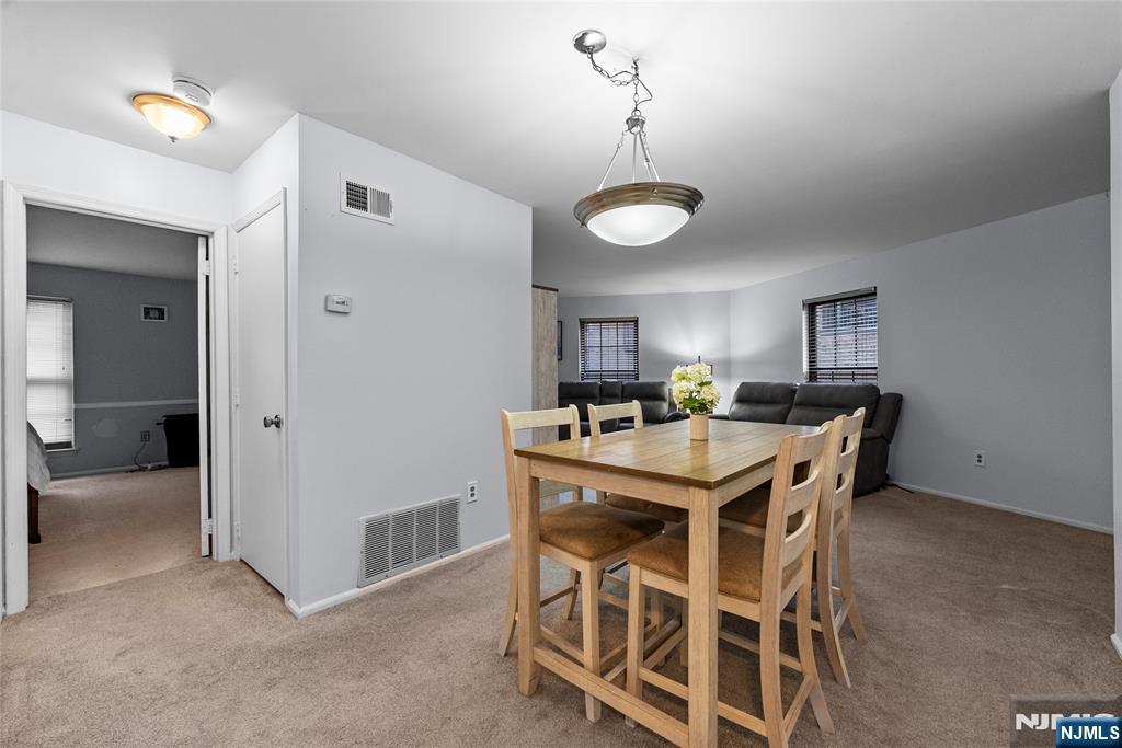 181 Long Hill Road, Unit 116 Little Falls, NJ 07424 - Photo 7 of 19 a view of a dining room with furniture