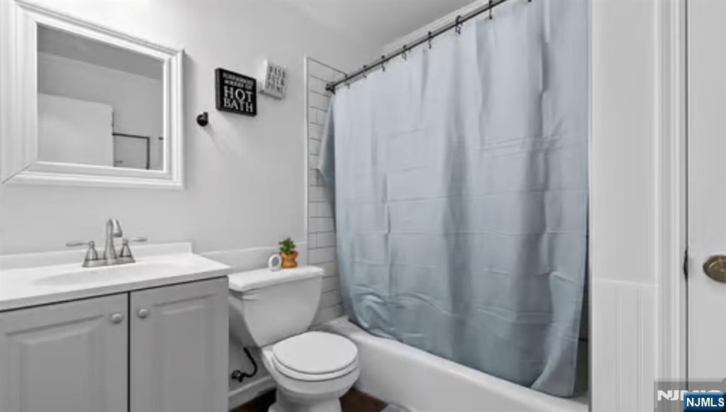 181 Long Hill Road, Unit 116 Little Falls, NJ 07424 - Photo 10 of 19 a bathroom with a sink a toilet and shower curtain