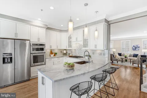 a kitchen with appliances a sink and cabinets