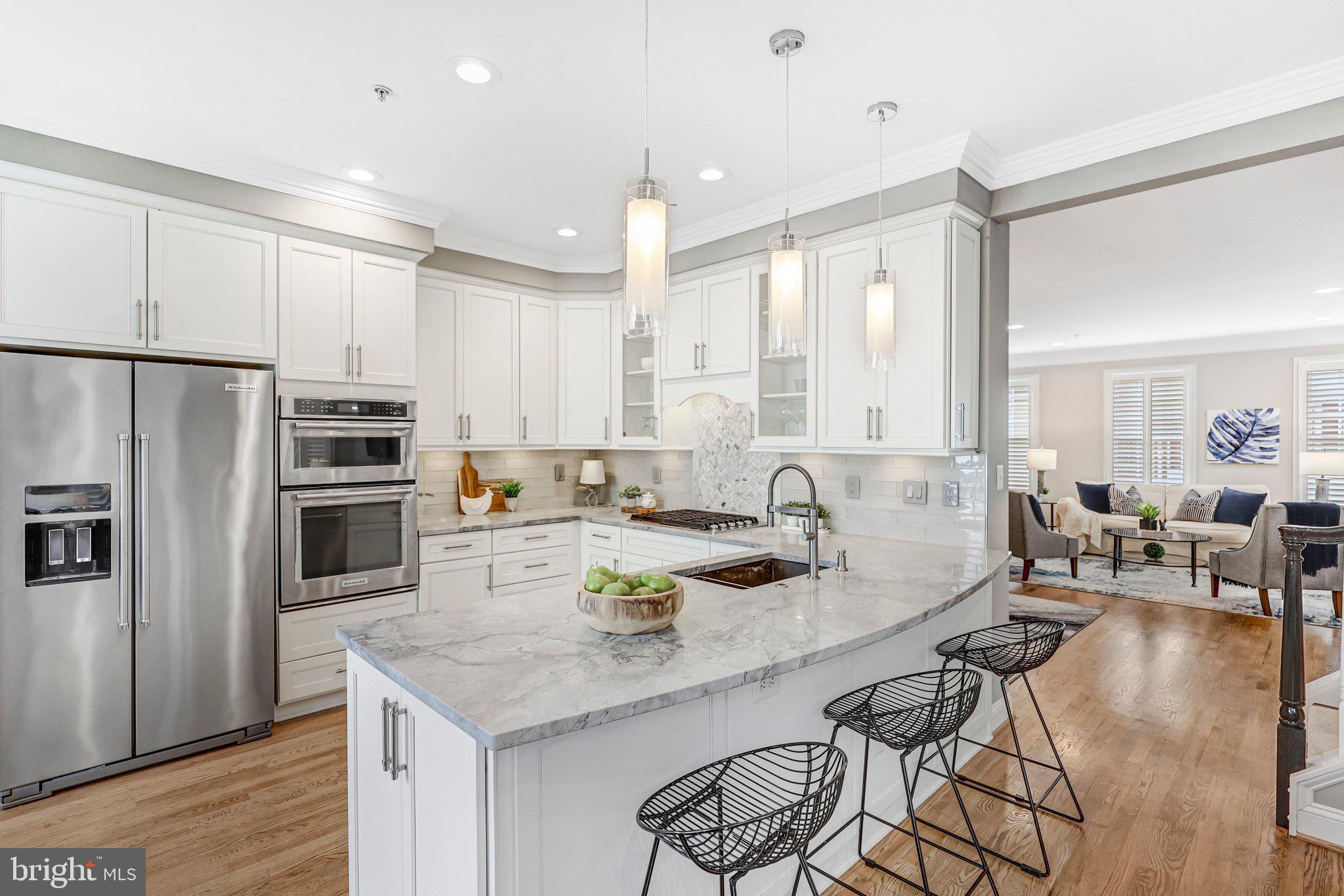 17 Alexander Street Alexandria, VA 22314 - Photo 11 of 49 a kitchen with stainless steel appliances granite countertop a stove refrigerator and chairs