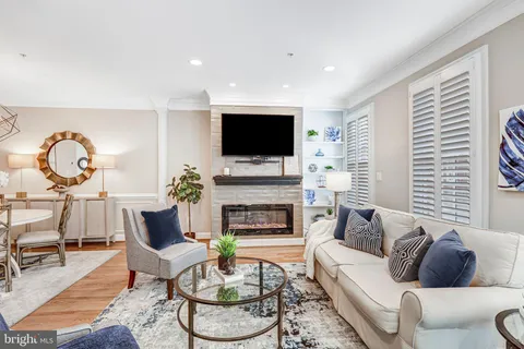 a kitchen with granite countertop stainless steel appliances white cabinets and a stove