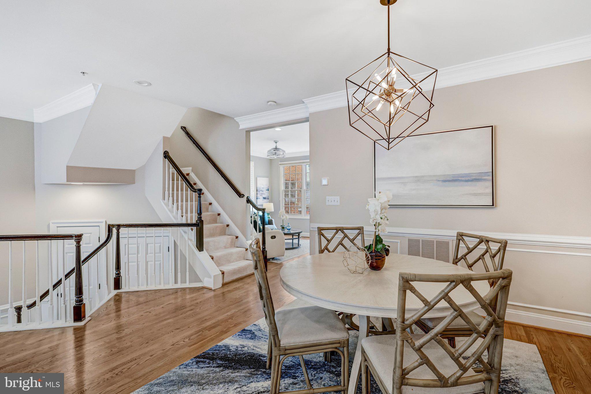 17 Alexander Street Alexandria, VA 22314 - Photo 24 of 49 a view of a dining room and livingroom with furniture wooden floor a chandelier