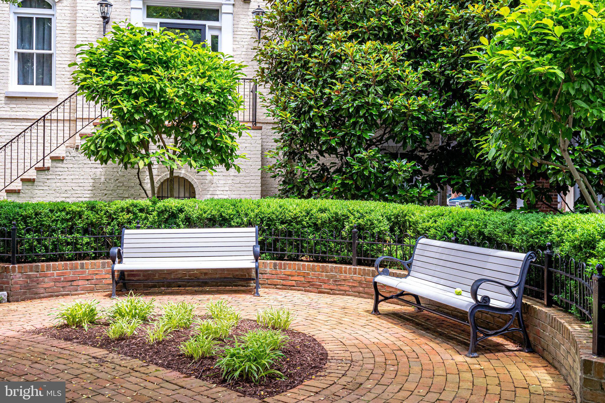 17 Alexander Street Alexandria, VA 22314 - Photo 49 of 49 a wooden bench sitting in backyard of a house
