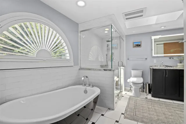 a bathroom with a sink a toilet and bathtub