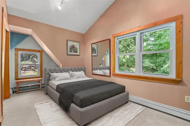 a bedroom with a large bed and a large window