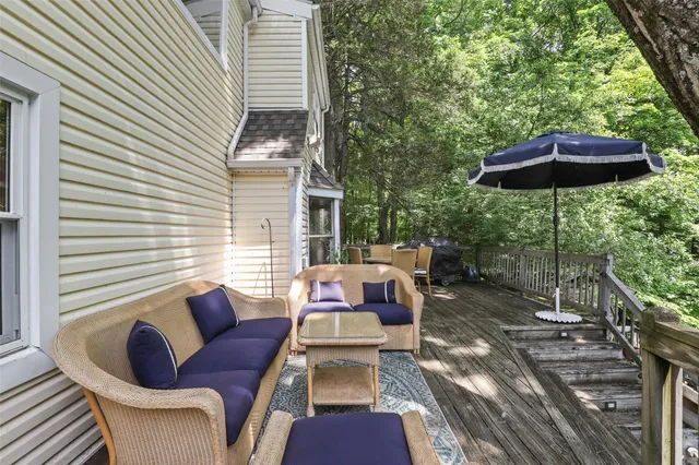 a view of a patio with a table and chairs under an umbrella