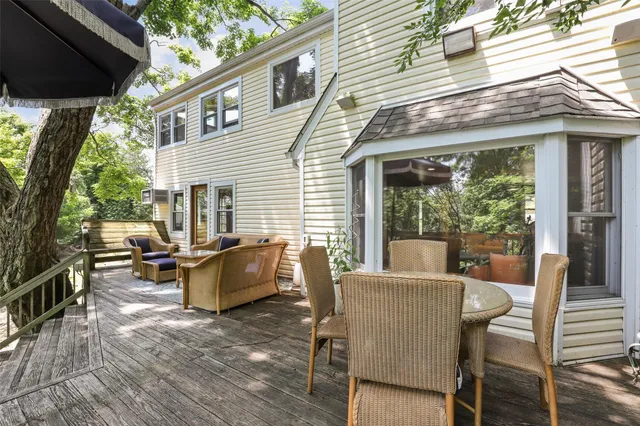 a view of a patio with table and chairs and wooden floor