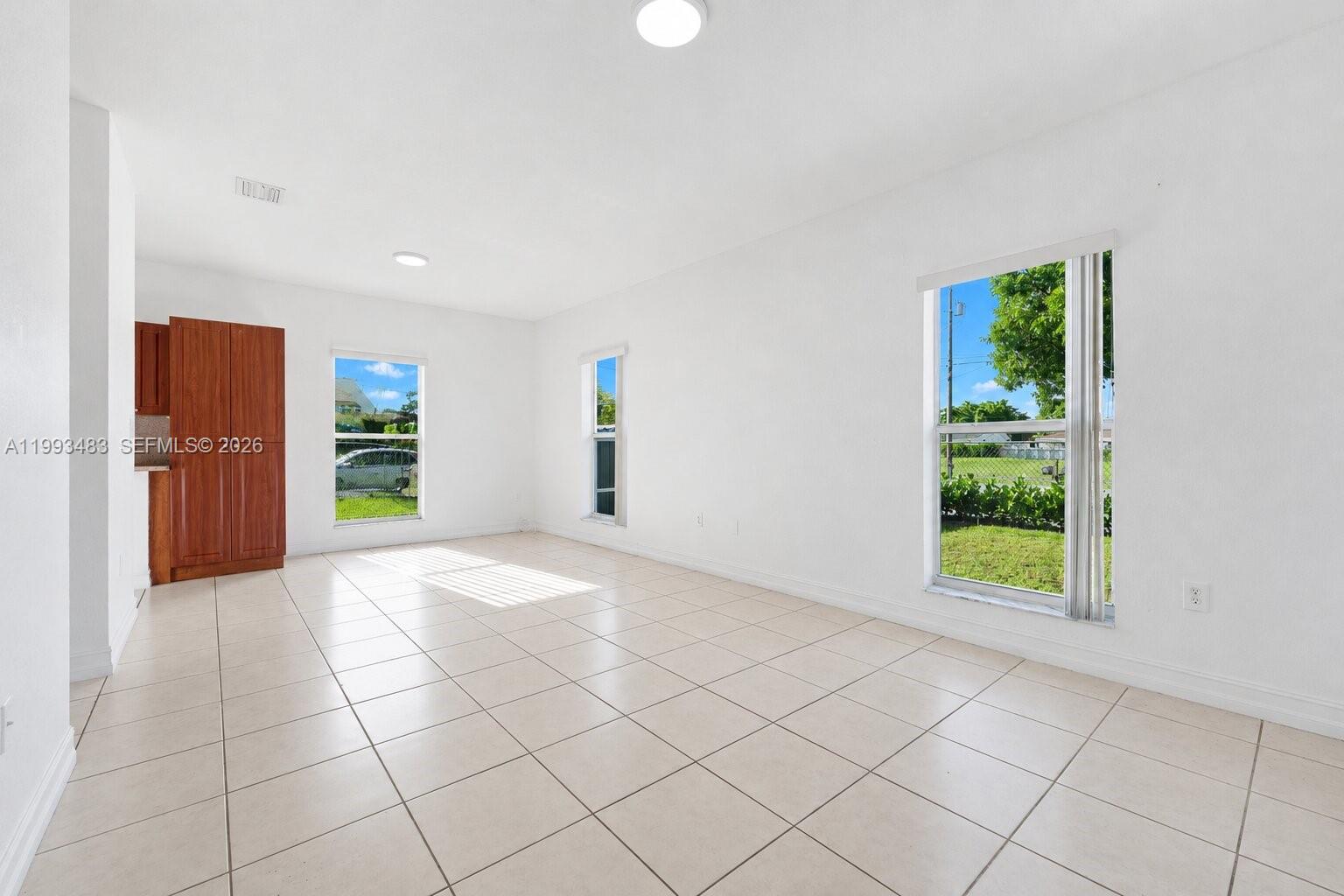10357 Southwest 178th Street, Unit 10357 Miami, FL 33157 - Photo 7 of 25 an empty room with windows