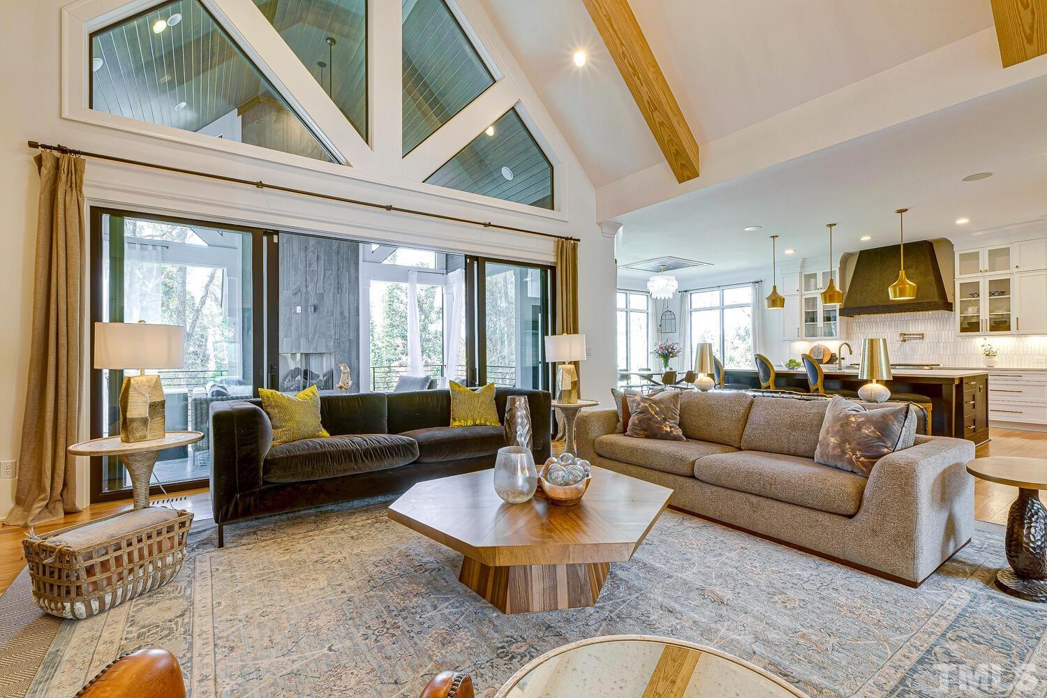 3521 Blue Ridge Road Raleigh, NC 27612 - Photo 12 of 100 a living room with furniture a fireplace and a large window
