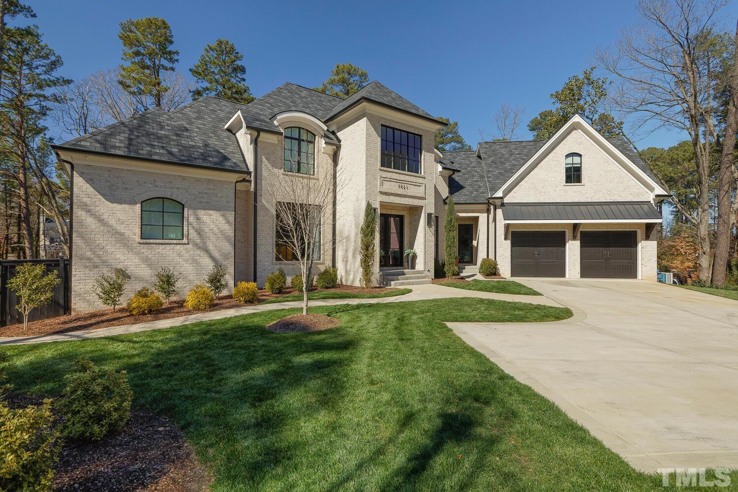 3521 Blue Ridge Road Raleigh, NC 27612 - Photo 2 of 100 a front view of a house with a yard and garage