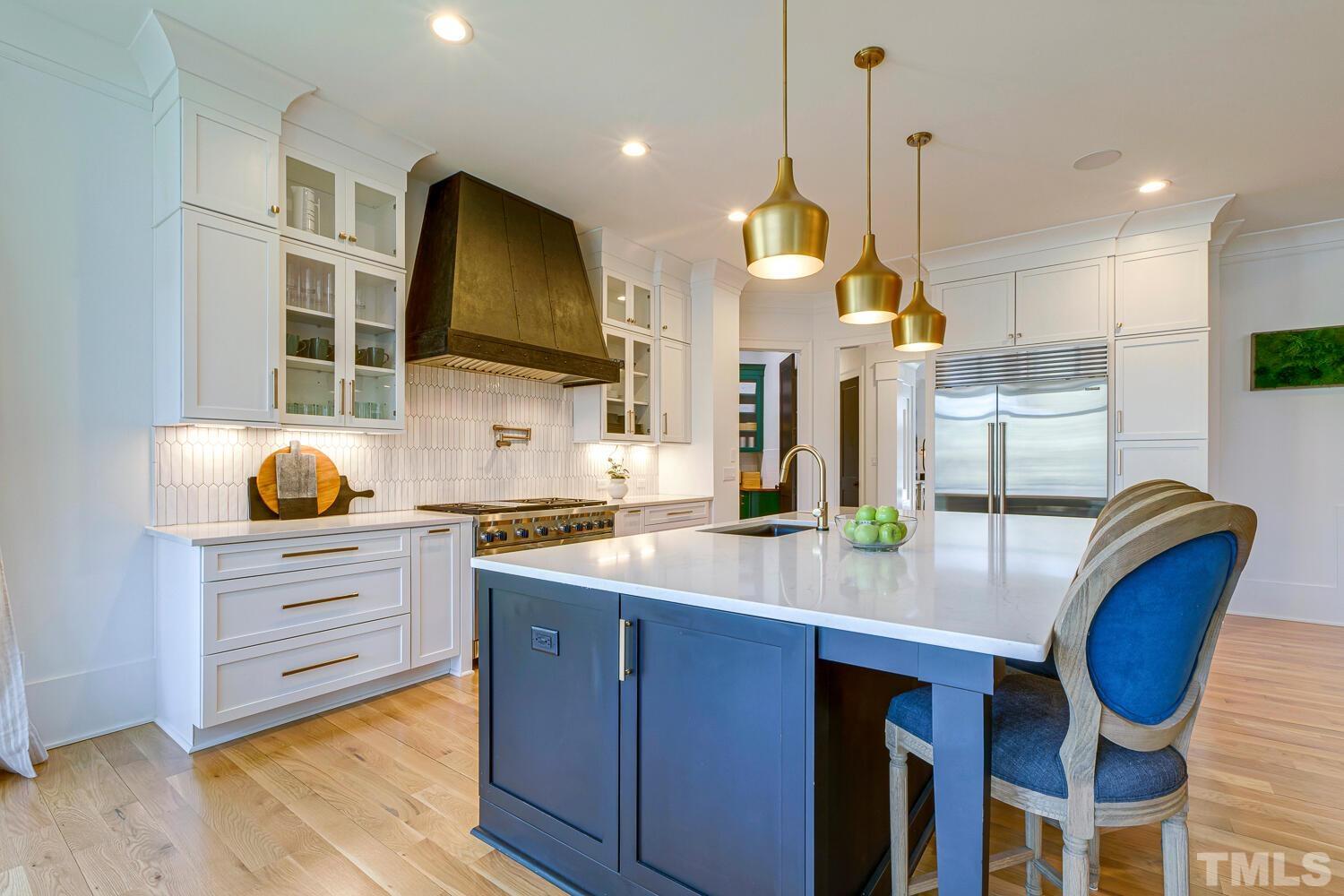 3521 Blue Ridge Road Raleigh, NC 27612 - Photo 21 of 100 a kitchen with stainless steel appliances granite countertop a stove a sink and a wooden floors