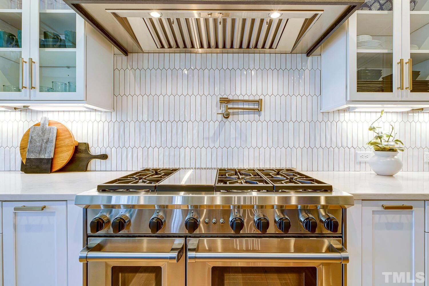 3521 Blue Ridge Road Raleigh, NC 27612 - Photo 24 of 100 a kitchen with a stove and a microwave