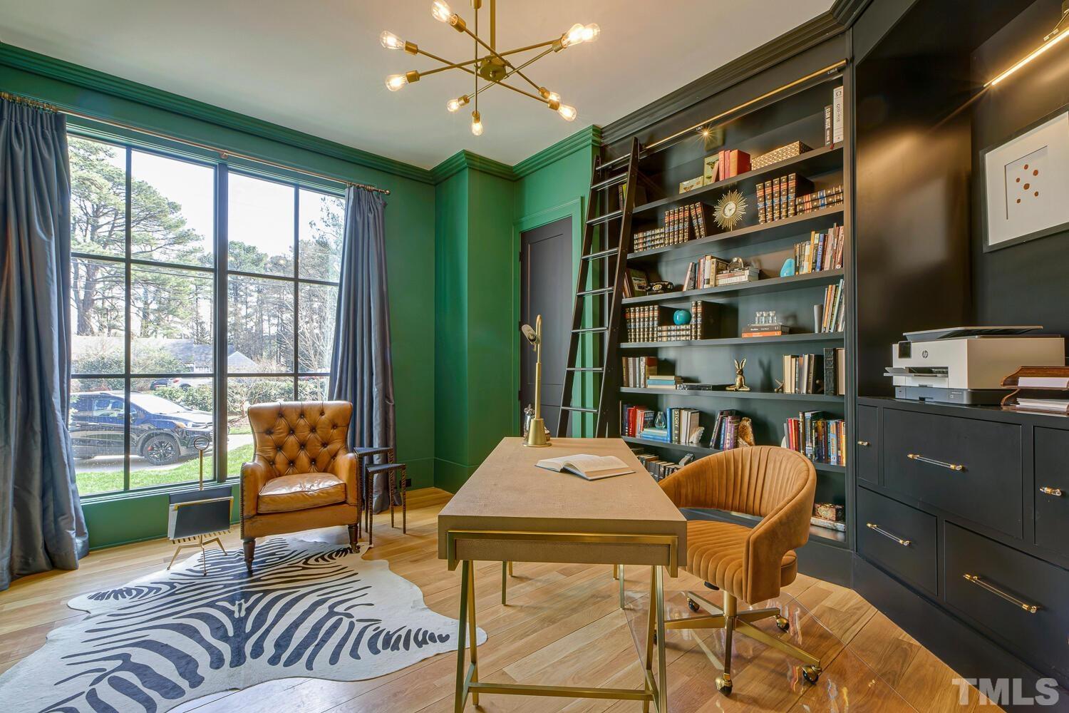 3521 Blue Ridge Road Raleigh, NC 27612 - Photo 37 of 100 a living room with furniture a bookshelf and a large window