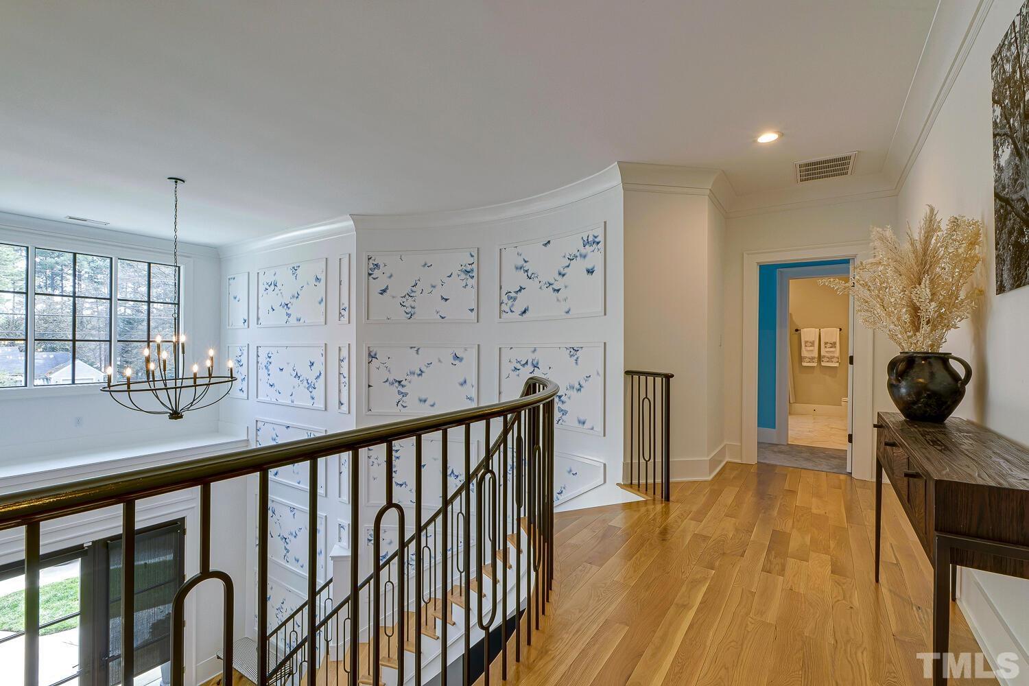3521 Blue Ridge Road Raleigh, NC 27612 - Photo 50 of 100 a view of a hallway with wooden floor and furniture