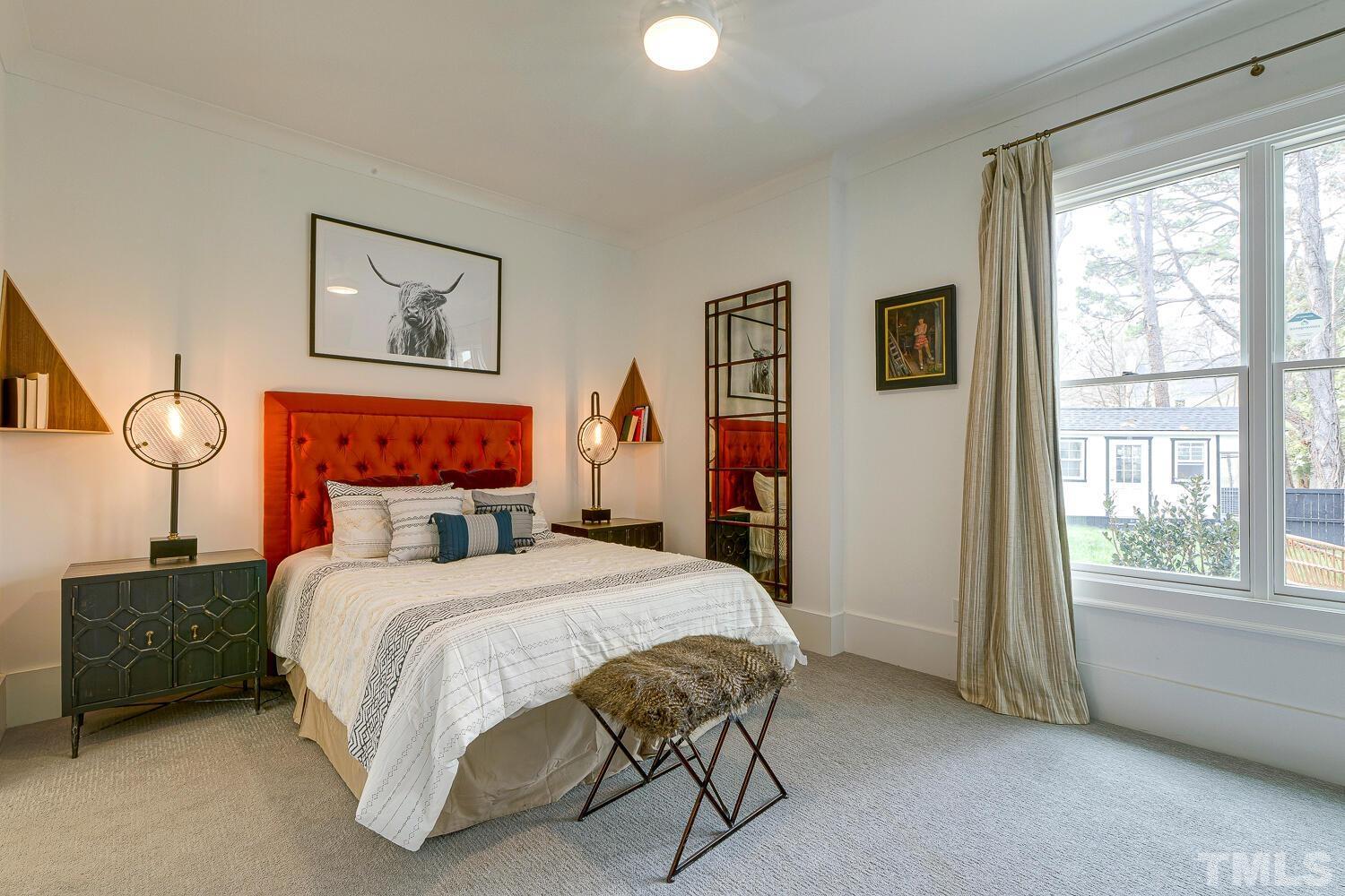 3521 Blue Ridge Road Raleigh, NC 27612 - Photo 80 of 100 a bedroom with a bed and a lamp next to a window