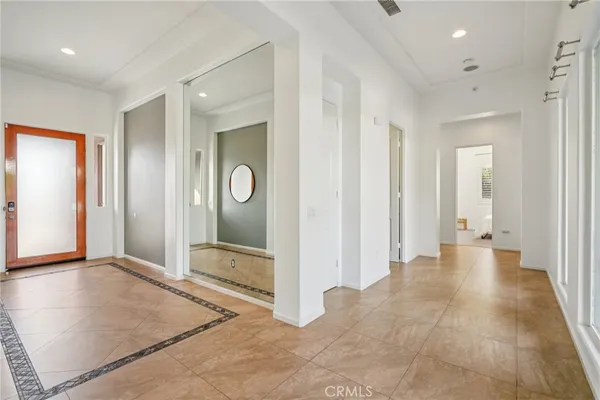 a living room with furniture kitchen view and a large window