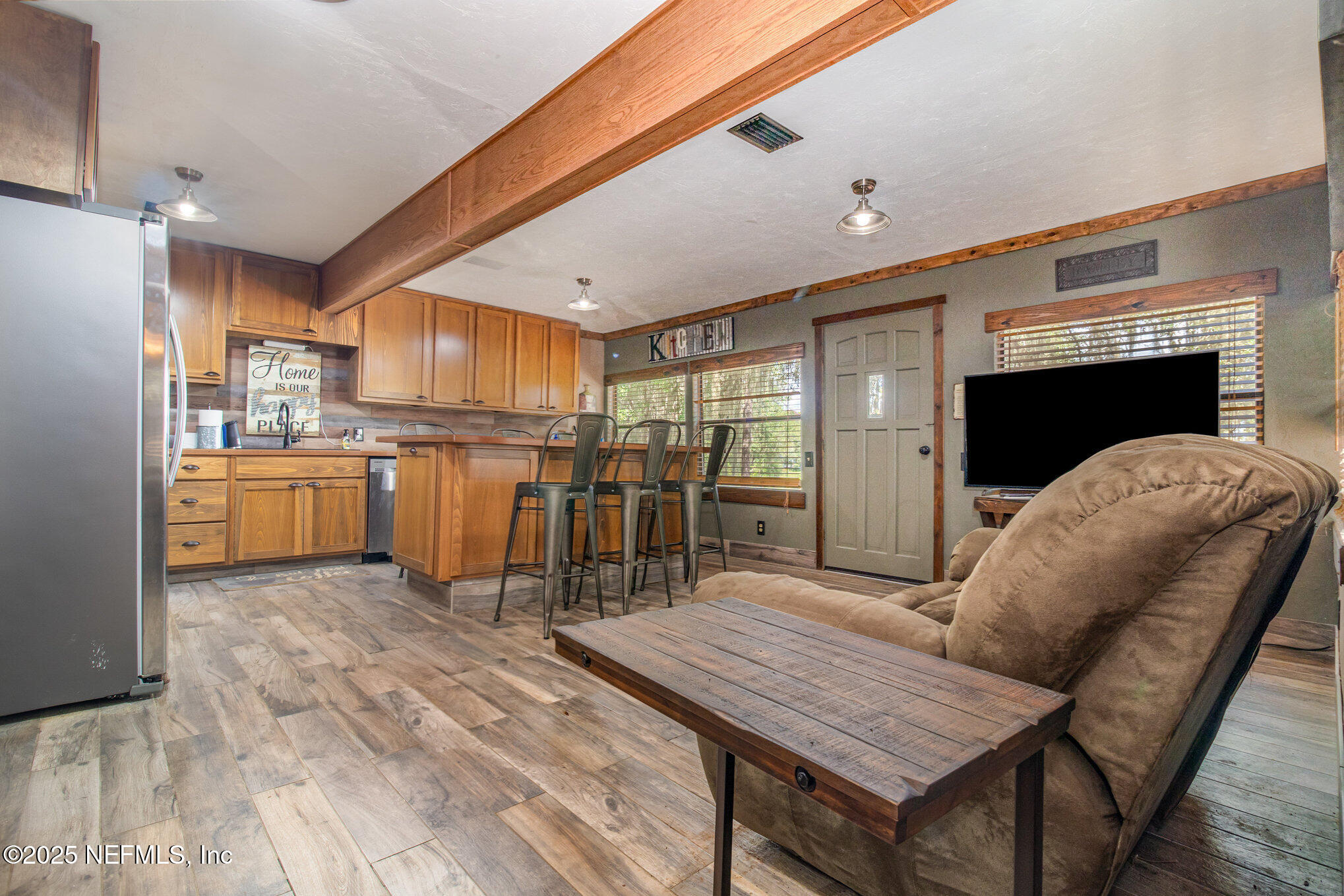 116 Lake Edge Trail Melrose, FL 32666 - Photo 2 of 9 a open kitchen with stainless steel appliances granite countertop a table chairs and a refrigerator