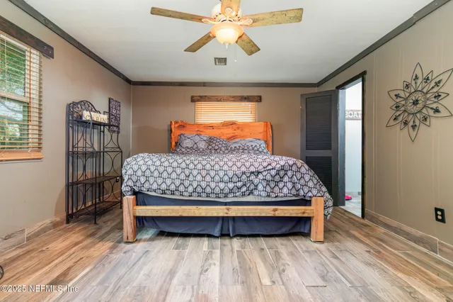 a bed sitting in a bedroom next to a window