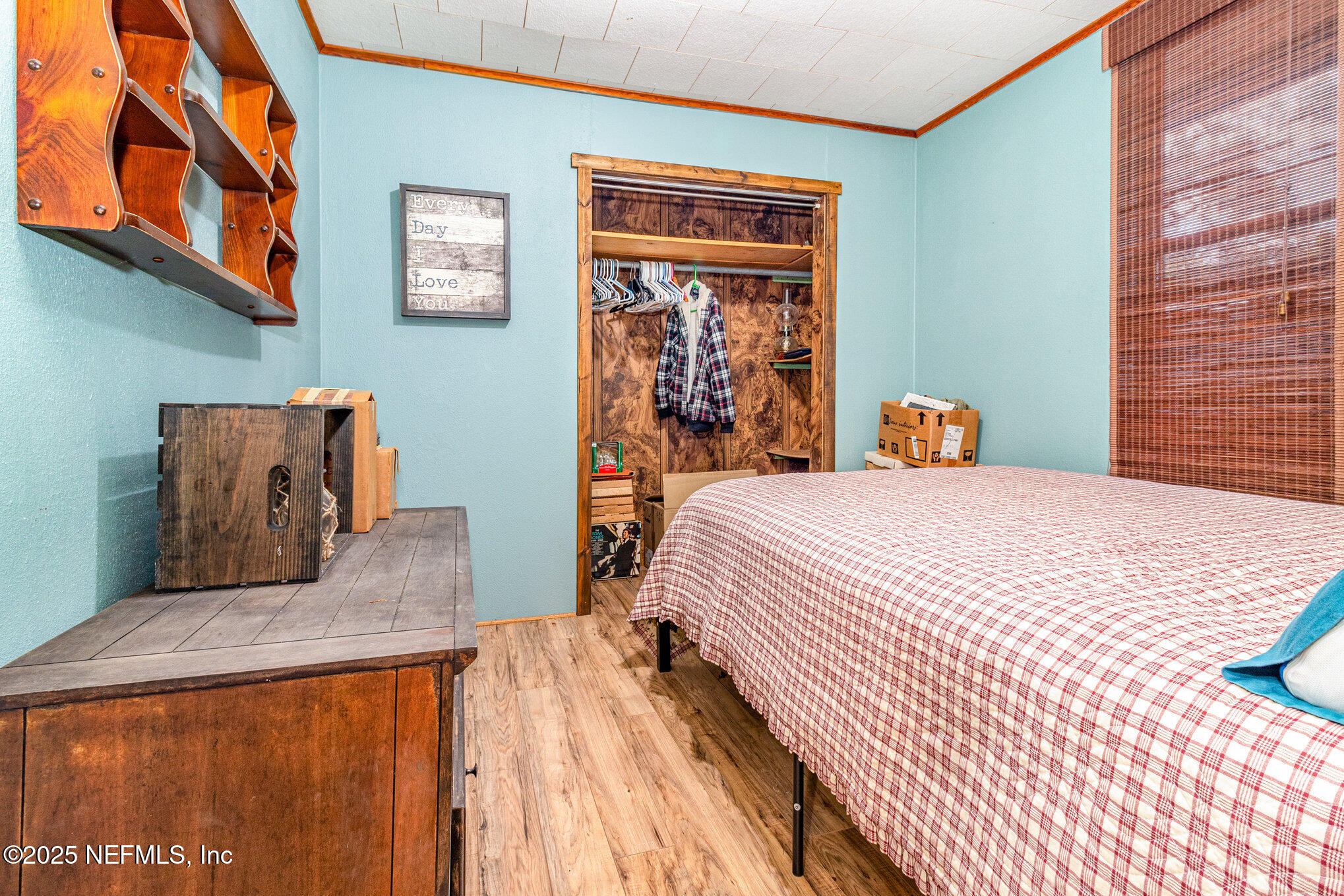 116 Lake Edge Trail Melrose, FL 32666 - Photo 6 of 9 a bedroom with a bed and wooden floor