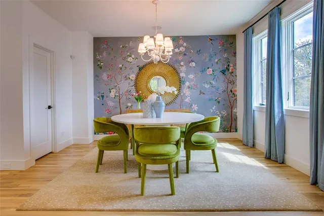 a view of a dining room with furniture and chandelier