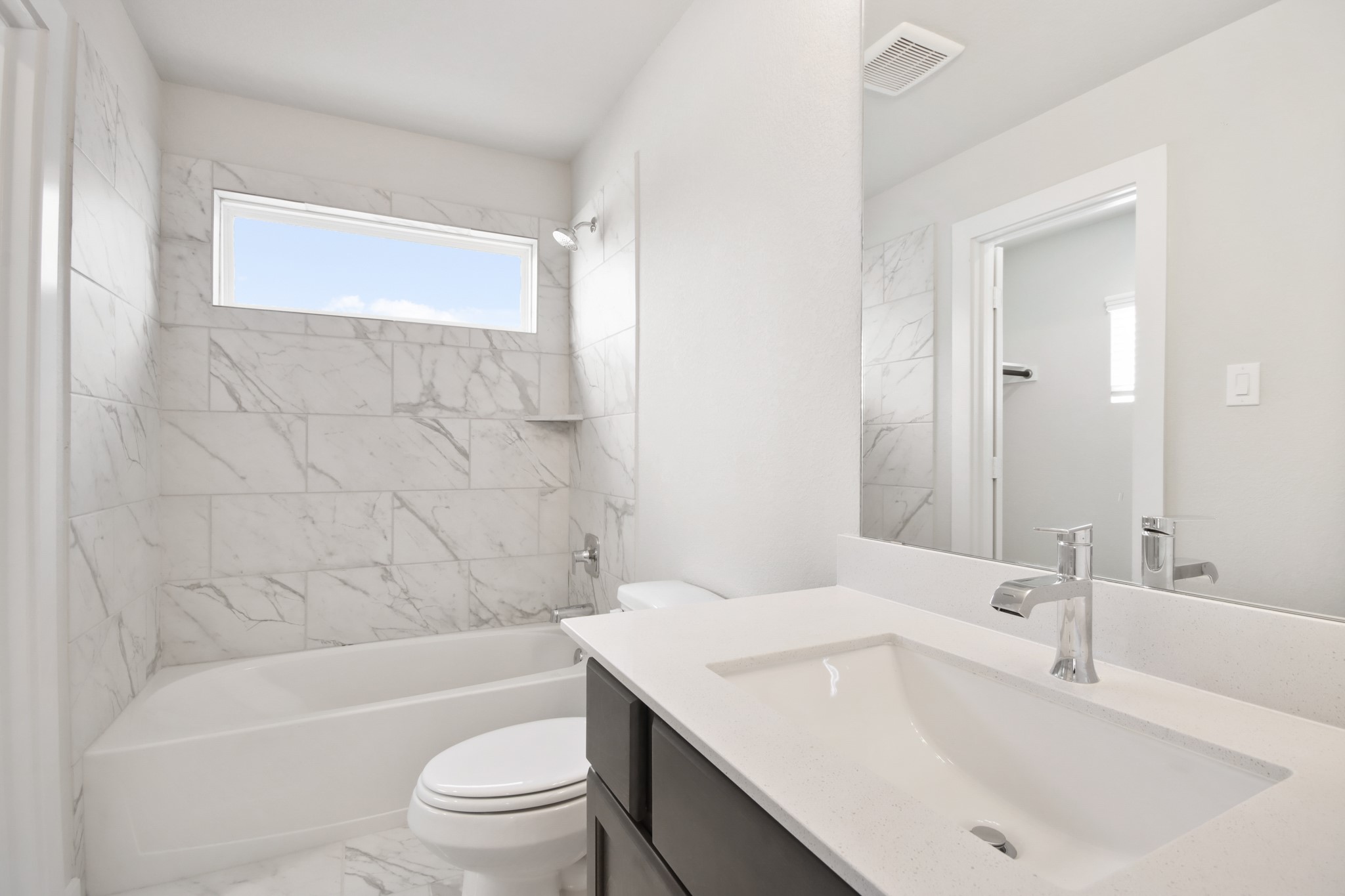 3211 Hawthorne Drive Conroe, TX 77301 - Photo 22 of 28 a bathroom with a bathtub shower sink vanity mirror and toilet