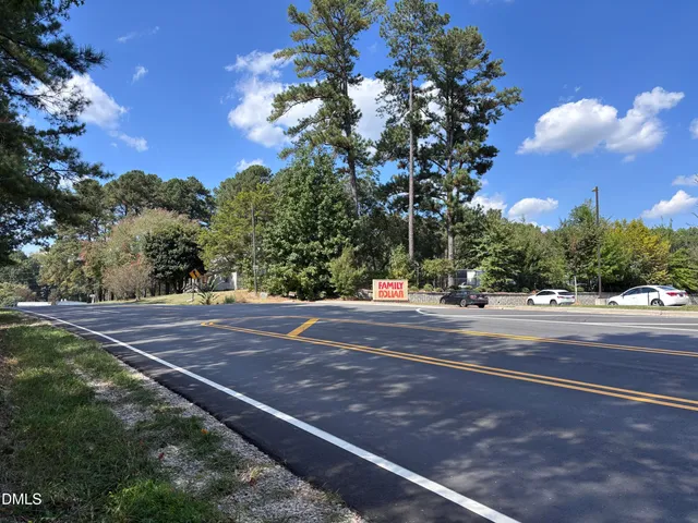 a front view of multi story residential apartment building with yard