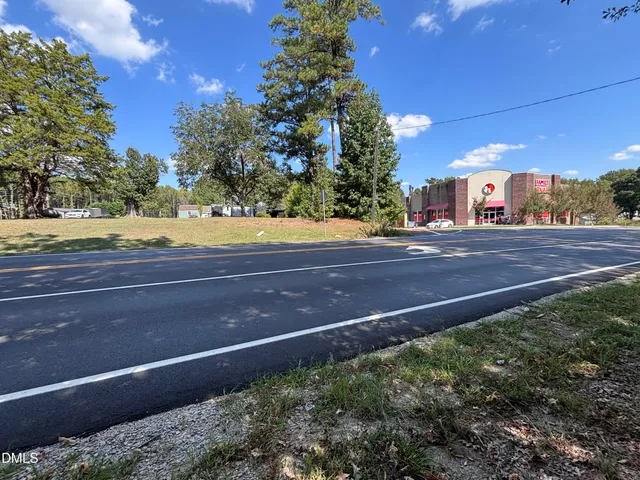a view of yard with swimming pool and green space
