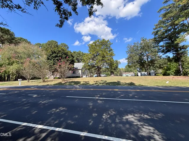 a view of swimming pool with outdoor seating and yard in back