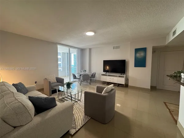 a living room with furniture and a flat screen tv