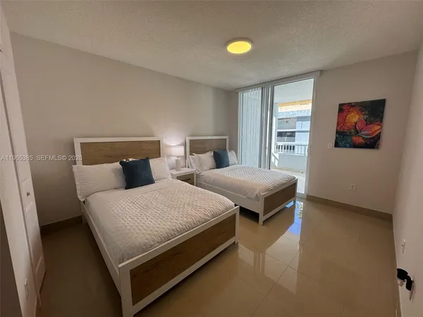 a spacious bedroom with a bed and window
