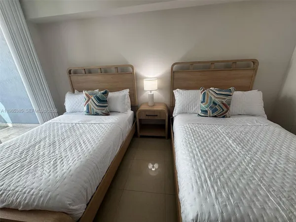 a bedroom with double bed and a night stand