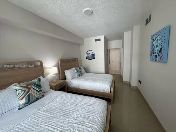 a bedroom with a bed and a lamp
