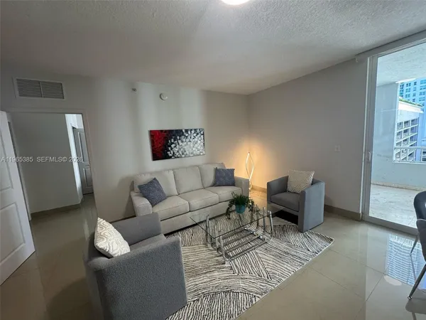 a living room with furniture and a rug