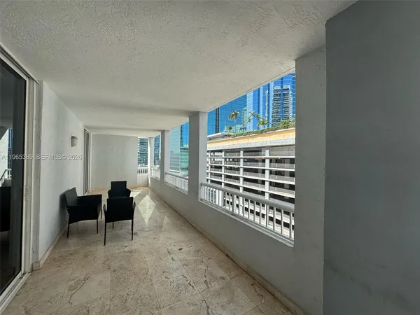 a view of a balcony with a white wall