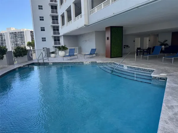 a view of a swimming pool with outdoor seating